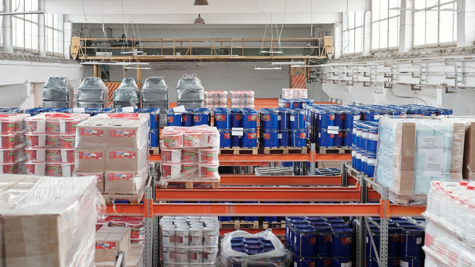Warehouse shelves filled with goods and pallets for marketplace inventory and fulfillment risk tracking