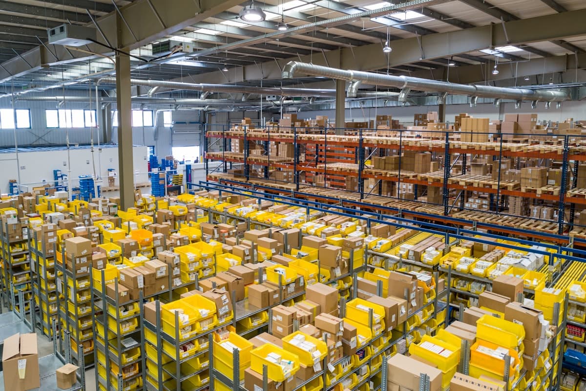 Warehouse shelves with organized inventory boxes representing safety stock buffer strategy for ecommerce brands